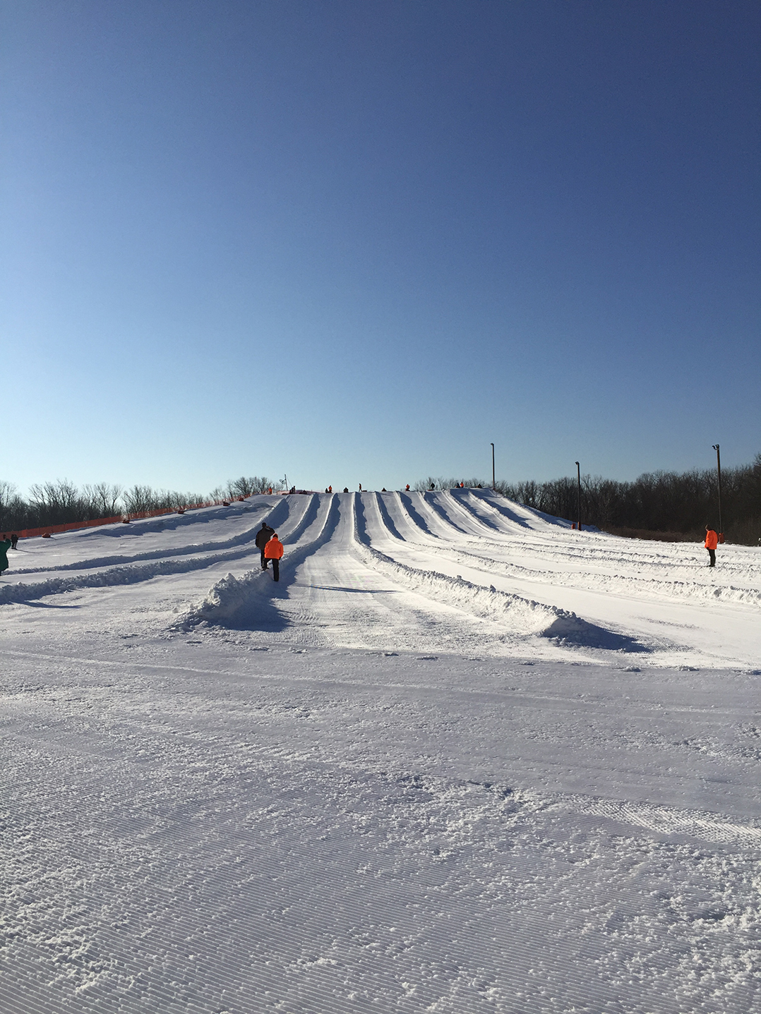 A toboggan approaches a snowy hill
